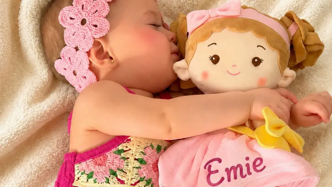 Baby girl cuddling  Milly Girl with baby’s name plush doll at bedtime