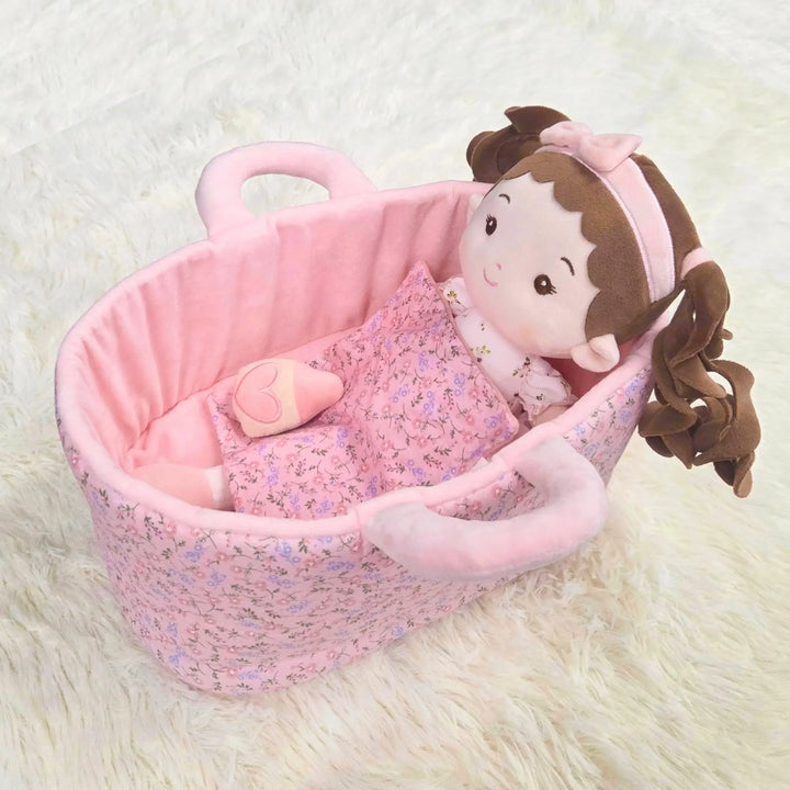 Princess Breeze plush doll lying in 13-inch Caregiver Playset bassinet with matching blanket for pretend doll care