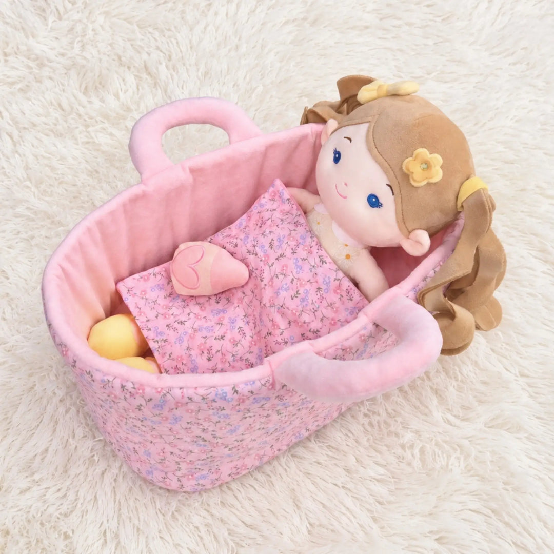Daisy Girl plush doll lying in 13-inch Caregiver Playset bassinet with matching blanket for pretend doll care