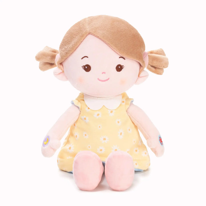 Layla soft talking doll in free extra yellow floral reversible outfit, seated front view