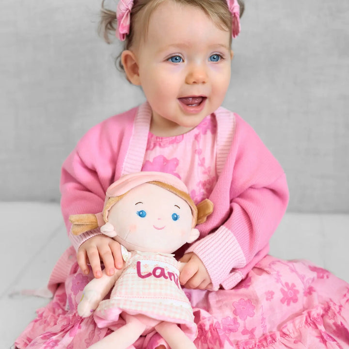 Baby girl playing with personalized Sophie talking doll during playtime