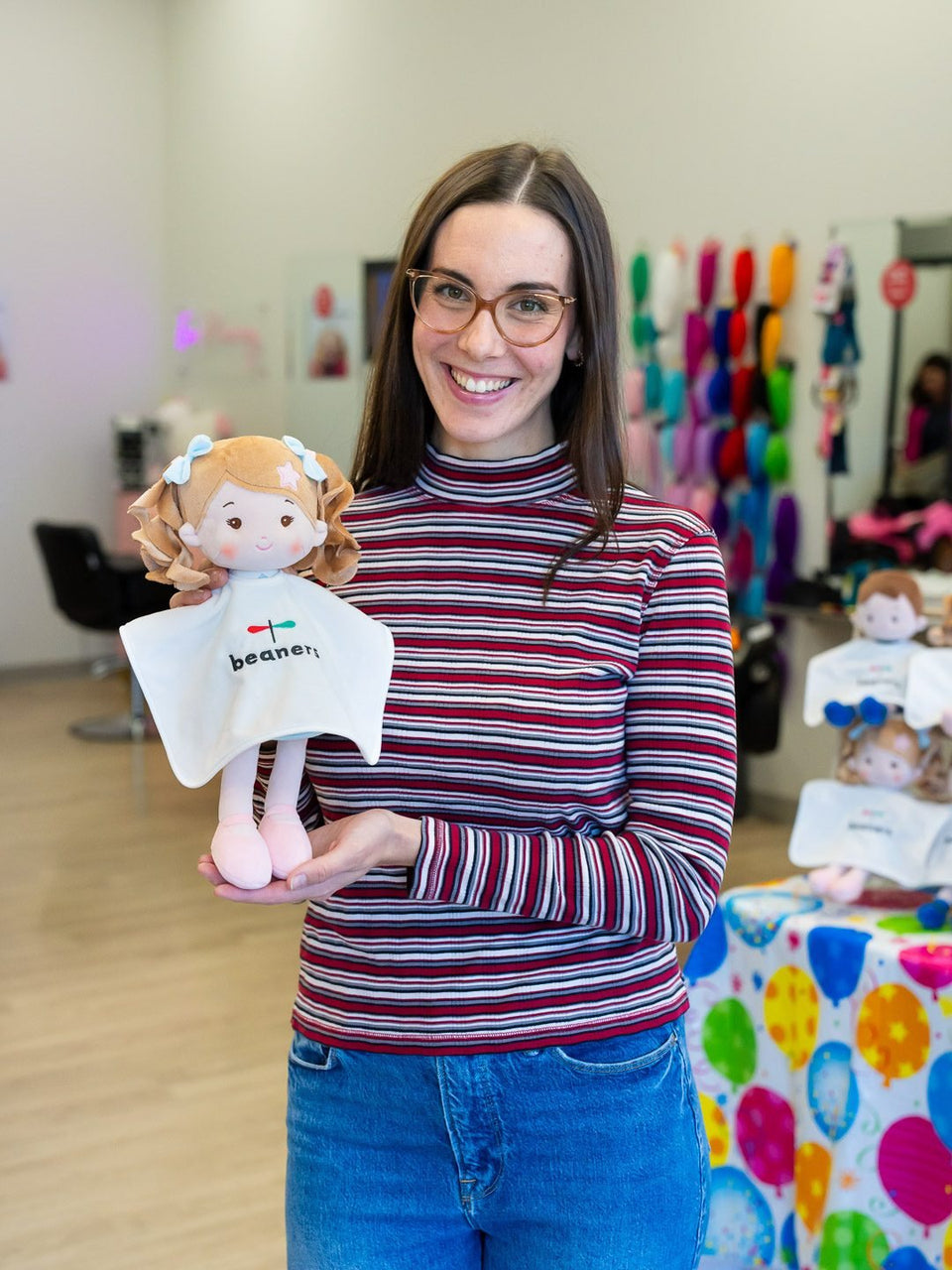 Beaners team member holding the co-branded doll